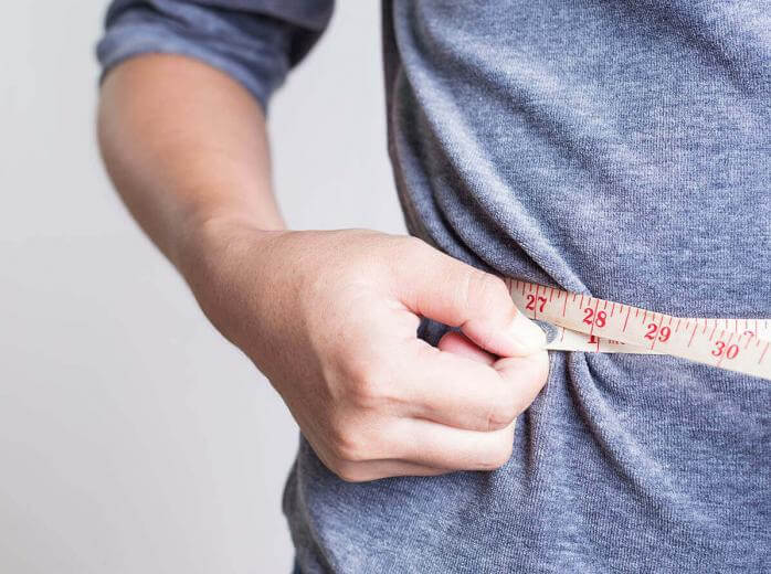 woman measuring waist